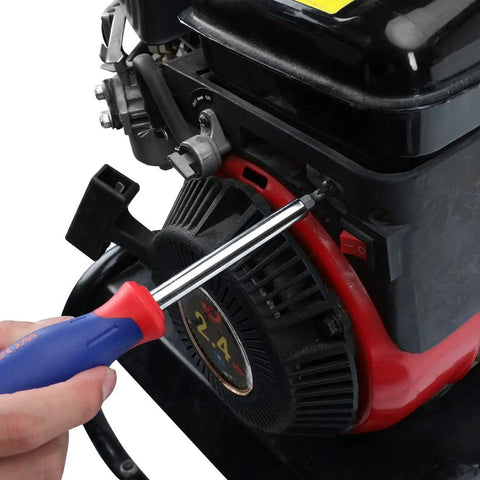 Person using screwdriver on engine close-up