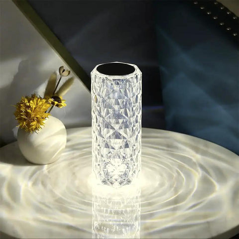 Lit Crystal Diamond Portable Table Lamp With 3 Color Touch Control placed on a table, showing glowing diamond-shaped acrylic surface.