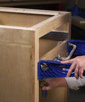 Person using Drawer Slide Jig With 3-Inch Face Clamps for Cabinets on wooden cabinet frame