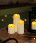 Remote Controlled Flameless LED Candles with Timer for Weddings and Parties on a wooden table beside a lantern