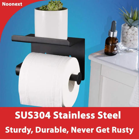Adhesive Stainless Steel Toilet Paper Holder With Shelf No Drilling Matte Black displaying a plant and toilet paper roll