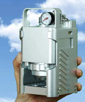 Portable Pneumatic Espresso Maker With 58mm Portafilter And Dual Pressure Gauges held against a blue sky.