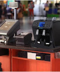 Top Tier Money Counter Machine For Mixed Denomination Bills Smooth Rolling Sorting With Multi Currency Support and Legit Bogus Buster Plus Printer on a checkout counter