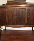 Antique bronze single hole cabinet pull on wooden furniture with vintage style for cupboards, drawers, or wardrobes