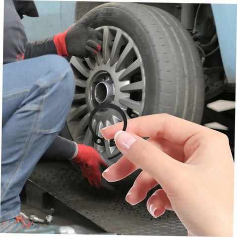 Two Pack Hydraulic Jack Circlip Retaining Snap Ring Set For External Circlips Easy Install Durable Steel Construction Portable Jack Stands Repair Kit For On The Go shown in hand with tire in background