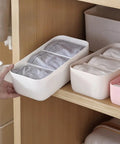Four Piece Plastic Drawer Organizer Box With Compartment Dividers For Bras Underwear And Socks Nifty Closet Storage Bins in a drawer.