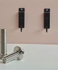 15 Piece Slatwall Hooks Set Heavy Duty Iron Display Hangers For Supermarkets And Retail Stores against pink wall