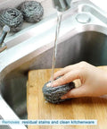 Hand using Heavy Duty Stainless Steel Scrubber Pads For Tough Kitchen Scrubbing On Dishes Pots Pans Ovens Grills And Sinks