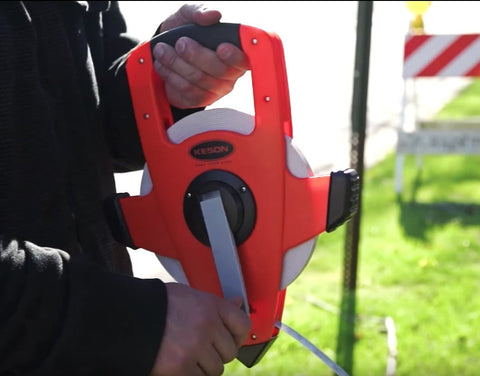 NRS18M330 Nylon Reinforced Tape Measure With Beast Speed Rewind and Double Hook in use, bright orange, 100M 330FT.