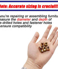 Five M6 slotted barrel nuts in a hand, demonstrating accurate sizing for furniture assembly hardware. Beast Mode 72 Piece M6 Metric Barrel Nuts And Cross Dowel Slotted Nut Kit.