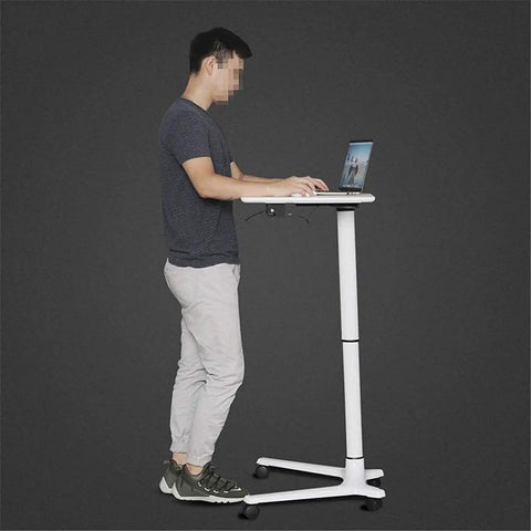 Man using Rock Solid Rolling Laptop Cart With Height Adjustable Standing Desk for relaxed work setup.