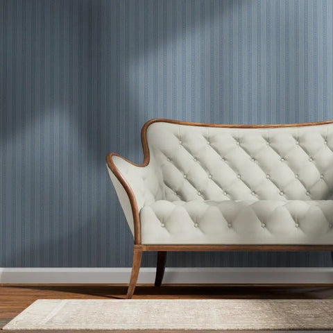 Blue Floral Stripe Wallpaper Featuring Silver Metallic Accents And Textured Fibrous Weave For Dope High End Vibes in living room with sofa.