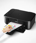 Hand retrieving a printed document from a Wireless All In One Color Inkjet Printer With Mobile And Tablet Printing, Auto Duplex Scanning, Compact Home Office Gear, Alexa Compatible, Smooth Plug And Play Setup For Real Photos, Sweet Results You Gonna Love Every Time.