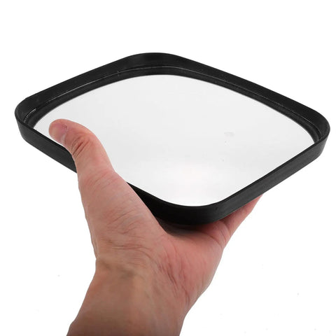 Hand holding a black-framed glass reflecting surface of a Wide Angle Safety Convex Mirror Rock Solid Wall Mount for Garage.