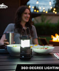 Pop Up IPX4 Water Resistant LED Lantern With 360 Degree Bright Light used outdoors, illuminating a table during an evening gathering.