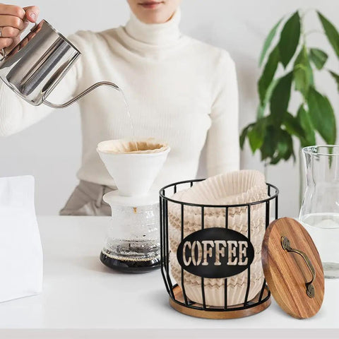Woman pouring coffee with Large Capacity Coffee Filter Holder With Lid, Pod Organizer For K Cups And Filters on countertop.