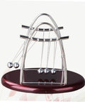 Large Newton Cradle Pendulum Desktop Physics Toy For Home Office Use Five Ball Demonstration on wooden base.