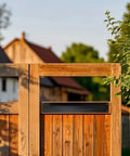 Heavy Duty 10 Inch Sliding Door Handle In Matte Black Stainless Steel Surface Mount on wooden gate with greenery backdrop.