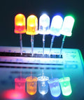 Array of lit LEDs in five colors on breadboard, 450 Piece 5mm LED Diode Kit With Five Colors White Red Yellow Green Blue For DIY Electronics Projects And Lighting Experiments Assorted Mini Round Top Light Emitting Diodes