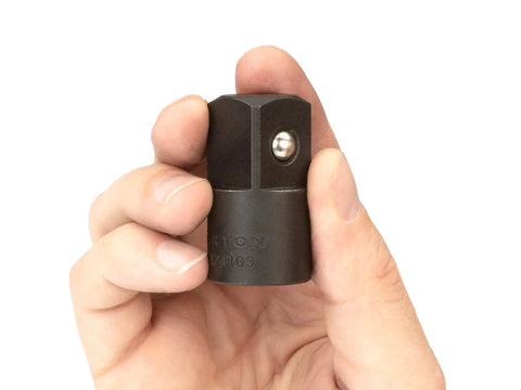 Close-up of a hand holding 1/2 Inch to 3/4 Inch Impact Drive Adapter for Impact Wrenches Converting 1/2 To 3/4 Inch, with Spring Loaded Detent Ball.