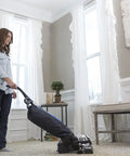 Person vacuuming carpet with Avalir using Cord Set Assembly For Avalir Vacuum 120V Black Replacement Cord OEM Authorized.