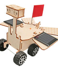 Close-up of Solar Powered Mars Rover Kit Made Of Wood for DIY Engineers with red flag, solar panels, and rubber wheels.