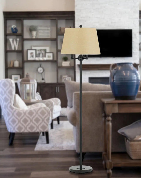 Traditional Four Light Floor Lamp In Bronze Finish From Andros Collection Stands Sixty Two Inches Tall With A Seventeen Inch Base Perfect For Your Living Room Or Reading Nook With A Cozy Glow in a living room setting