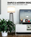 Tall 62 Inch Floor Lamp With Black Metal Base, White Fabric Drum Shade And 9W LED Bulb in modern living room setting