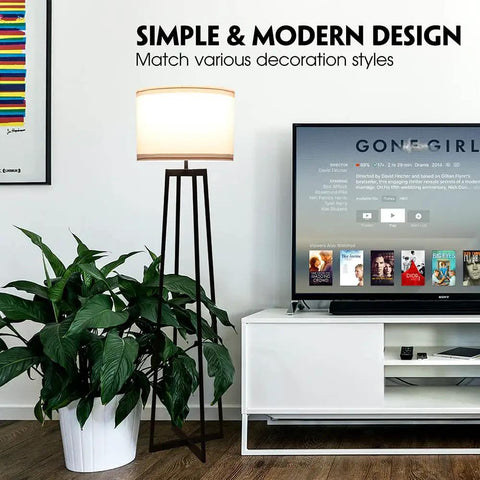 Tall 62 Inch Floor Lamp With Black Metal Base, White Fabric Drum Shade And 9W LED Bulb in modern living room setting