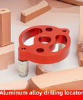Boss Grade Self Centering Doweling Jig Kit With Knockout Wood Drill Guide showing a red aluminum drilling locator on wooden pieces.