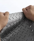 Hands holding heavy duty red PVC garage floor mat roll 1.5x2m cuttable, non slip, easy to clean, durable floor protector texture