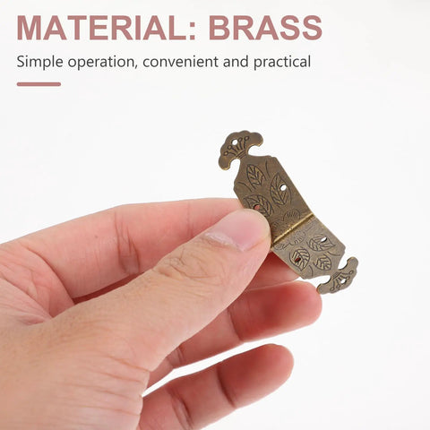 Hand holding Brass Corner Protectors For Jewelry Boxes And Woodworking Projects Antique Style Box Corner Guards
