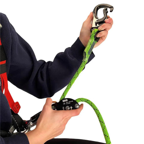 Person adjusting Renegade Adjustable Lanyard For Work Positioning With Ergonomic Lever, attached to harness D ring, green rope