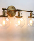 Three Light Antique Brass Wall Sconces With Clear Glass Globes Dope Industrial Vanity Lighting For Bathroom And Living Room