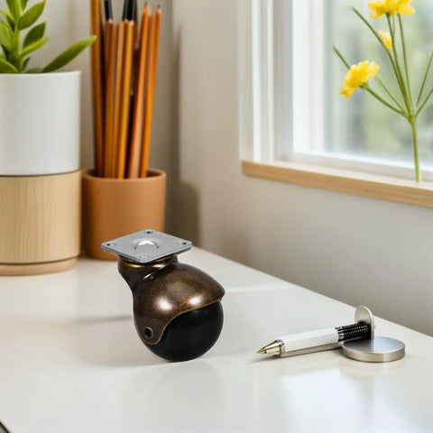 Heavy Duty 2 Inch Swivel Ball Caster with a sleek black wheel and metal flat mounting plate on a desk, ideal for furniture.