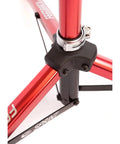 Close-up of Sprint Bike Repair Stand with tripod base, showing the durable red frame and dropout style mount with clamp.