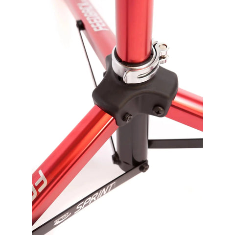 Close-up of Sprint Bike Repair Stand with tripod base, showing the durable red frame and dropout style mount with clamp.