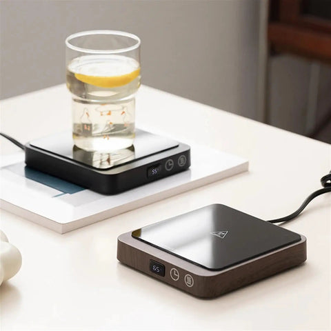 Never Suffer Through Lukewarm Coffee Again With This 20W Adjustable Mug Warmer on desk keeping drink hot all day.