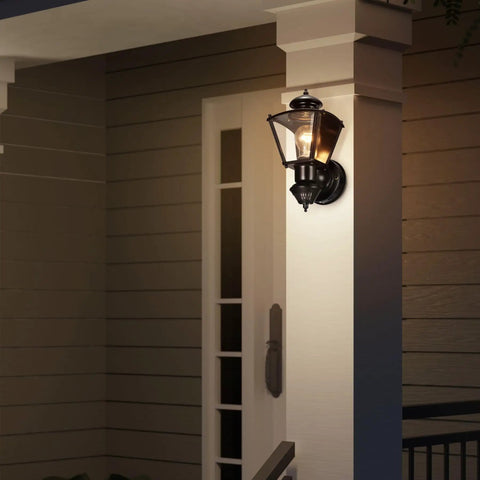 Four Sided Motion Activated Coach Light Outdoor Porch Lantern In Black Brass Charleston Style Exterior Lighting With 150 Degree Sensor And Up To 30 Feet Detection For Easy Economical Nighttime Illumination illuminating a porch entrance.