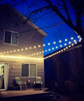 Outdoor String Light Hanging Kit With 100Ft Black Vinyl Coated 304 Stainless Steel Cable Globe String Lights Suspension Setup Includes Wire Rope Tension Turnbuckle And Eye Hooks For Easy Reliable Install lighting up a backyard patio space.