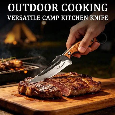Versatile camp kitchen knife cutting steak on wooden board