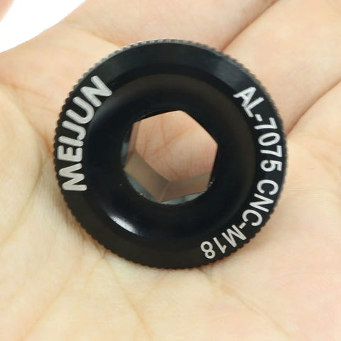 Beefy M18 Crank Arm Bolt Aluminum Alloy in black, CNC machined threads, held in a hand, cycling part for mountain bike crank cover.