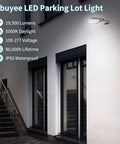 2 Pack 150W LED Parking Lot Light With Dusk To Dawn Photocell illuminating building exterior