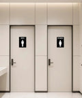 Restroom doors with men and women signs in a modern interior setting.