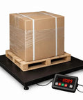 Heavy Duty Floor Scale Featuring A Spacious 48 By 48 Inch Deck And Massive 11000 Pound Capacity built like a tank with a box on a pallet.