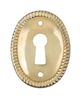 Vertical Oval Stamped Brass Keyhole Cover With Slick Retro Vibes, 1 By 1 1/2 Inch, showing keyhole and decorative edging.