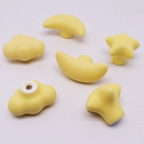 Standout Six Piece Set Of Bright Yellow Ceramic Cabinet Knobs Packing Dang Cool Star Moon And Cloud Shapes To Level Up Your Nursery Dresser Or Kitchen Cupboard Hardware Setup Today featuring cheerful shapes.