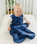Baby in crib wearing Ultimate Baby Sleep Sack For 4 Season Merino Wool Sleeping Bag With Organic Cotton Outer Night Sky design