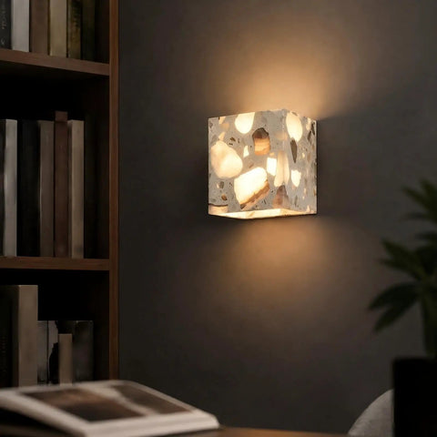 4.7" Mid Century Modern Wall Sconce, Minimalist Terrazzo Wall Light Fixture illuminating a dark wall with dappled shadows.