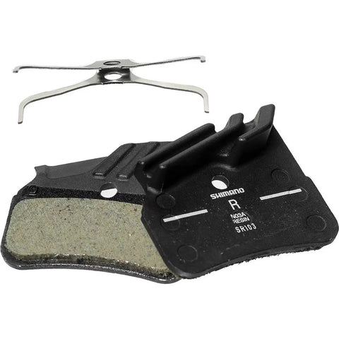 N03a Grey Resin Disc Brake Pads For All Conditions With Grippy Finned Back Plate, shown with metal spring.